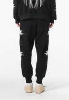 Pantalón jogger Wings con parches Mini Wings en los laterales | MWM [PS_COLORS:BLACK]