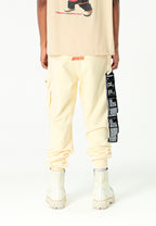 Pantalón jogger Vanguard Dogs con bolsillo cargo lateral y bordado trasero | MWM [PS_COLORS:ECRU]