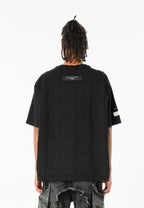 Camiseta de corte relajado con diseño entrelazado y tachuelas en los hombros | MWM [PS_COLORS:BLACK]