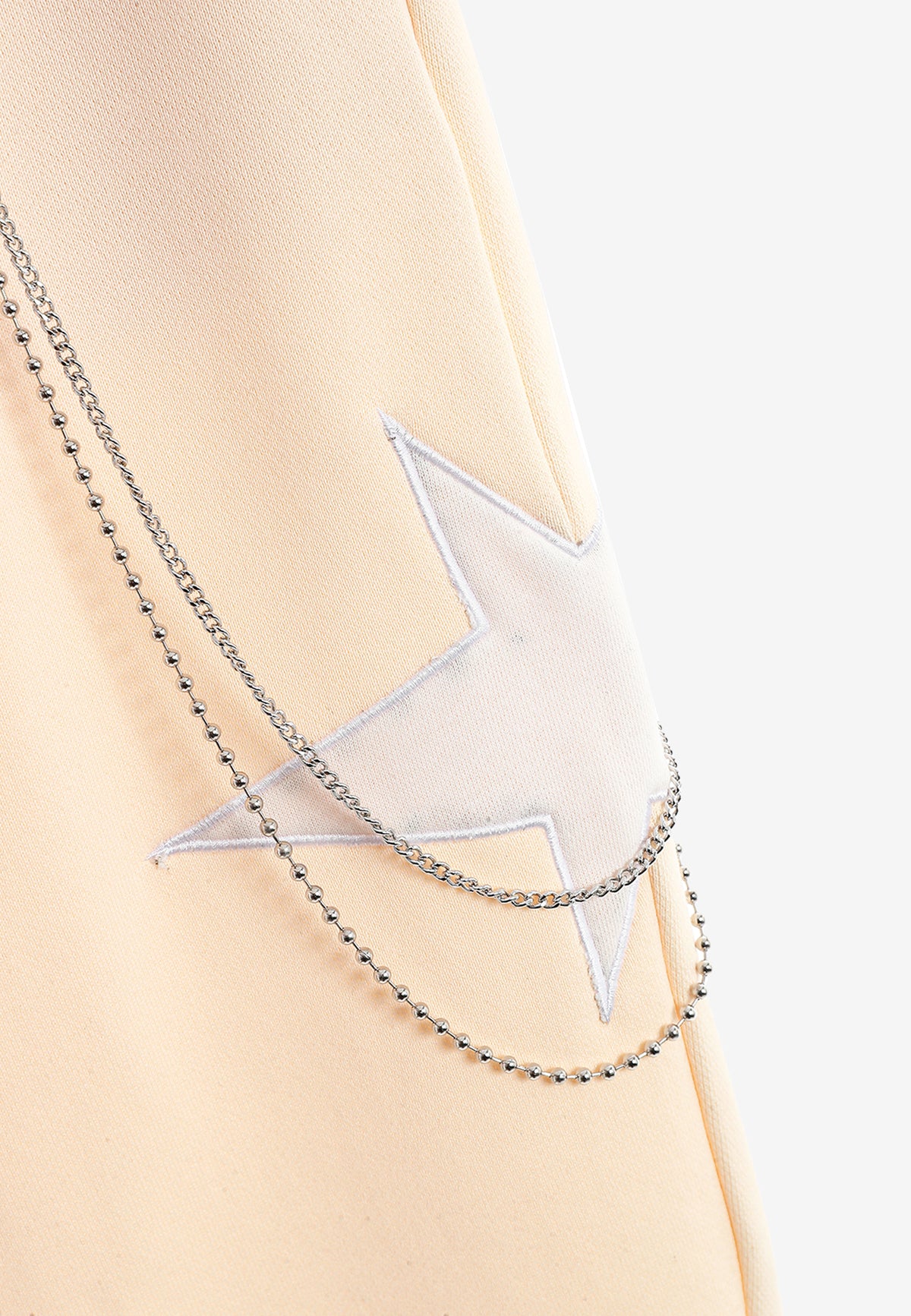 Pantalón jogger de niño Wings con parches de estrellas y cadena lateral | MWM [PS_COLORS:BEIGE]